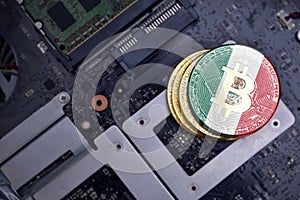 Golden bitcoins with flag of mexico on a computer electronic circuit board. bitcoin mining concept