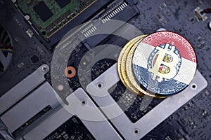 Golden bitcoins with flag of missouri state on a computer electronic circuit board. bitcoin mining concept