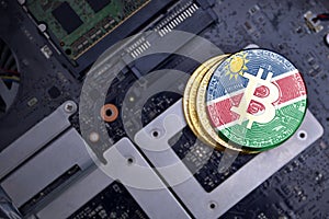 Golden bitcoins with flag of namibia on a computer electronic circuit board. bitcoin mining concept
