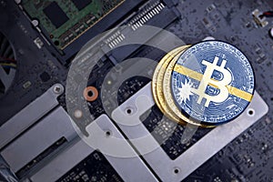 Golden bitcoins with flag of Nauru on a computer electronic circuit board. bitcoin mining concept