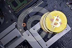 Golden bitcoins with flag of new mexico state on a computer electronic circuit board. bitcoin mining concept