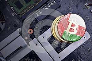 Golden bitcoins with flag of oman on a computer electronic circuit board. bitcoin mining concept