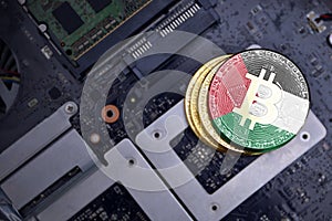 Golden bitcoins with flag of palestine on a computer electronic circuit board. bitcoin mining concept