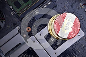 Golden bitcoins with flag of peru on a computer electronic circuit board. bitcoin mining concept