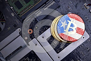 Golden bitcoins with flag of puerto rico on a computer electronic circuit board. bitcoin mining concept