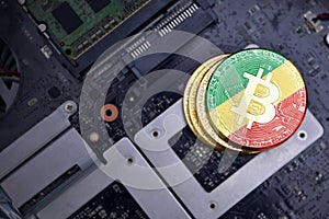 Golden bitcoins with flag of republic of the congo on a computer electronic circuit board. bitcoin mining concept