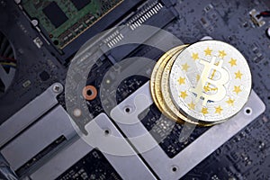 Golden bitcoins with flag of rhode island state on a computer electronic circuit board. bitcoin mining concept