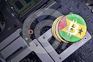 Golden bitcoins with flag of sao tome and principe on a computer electronic circuit board. bitcoin mining concept