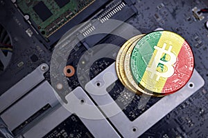 Golden bitcoins with flag of senegal on a computer electronic circuit board. bitcoin mining concept