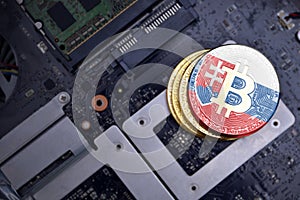 Golden bitcoins with flag of slovakia on a computer electronic circuit board. bitcoin mining concept