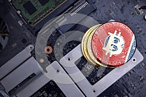 Golden bitcoins with flag of tennessee state on a computer electronic circuit board. bitcoin mining concept