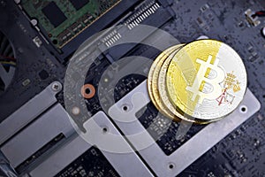 Golden bitcoins with flag of vatican city on a computer electronic circuit board. bitcoin mining concept