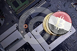Golden bitcoins with flag of yemen on a computer electronic circuit board. bitcoin mining concept