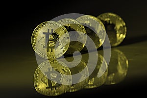 Golden bitcoins with reflection on marble desk. Electronic money, cryptocurrency