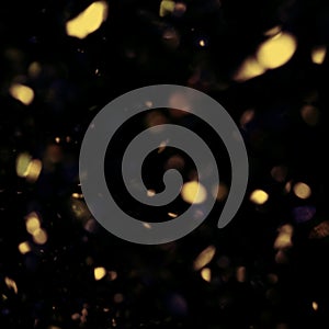golden and black background with glitter colorful circles bokeh lights for christmas and winter holiday
