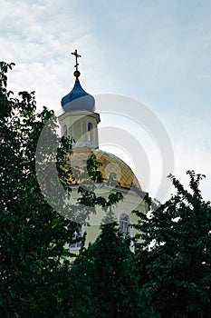 Golden and blue domes with crosses of a blue sky