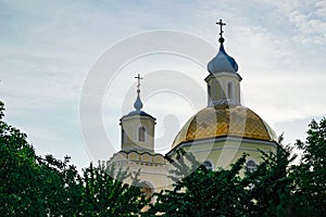 Golden and blue domes with crosses of a blue sky