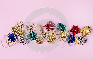 Golden Blue Red Gift Ribbons in Shape of Flowers and Goldden Ribbons Serpantine on Pink Background Holidays Festive Flat Lay Above