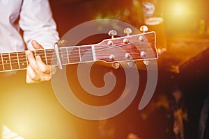 Golden Blues. Man`s male hands playing the guitar , singer solo vocal woman on wooden wall background, electric or acoustic guitar