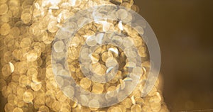 Golden bokeh defocused glitter, abstract background with yellow hot bokeh