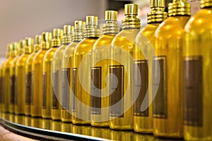 Golden bottles in a row, perspective shot