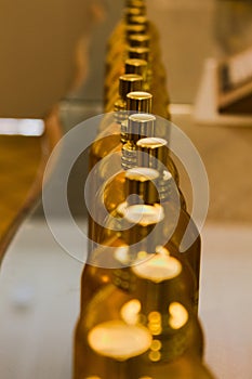 Golden bottles in a row, perspective shot from above