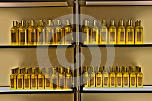 Golden bottles in a row on a shelf.