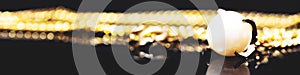 Golden bracelet with white pearl in it, in front of a black background