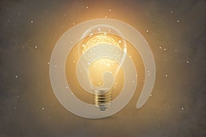 Golden brain glowing inside light bulb on paper texture backgrond