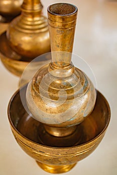 A golden brass pour ceremonial water jar.