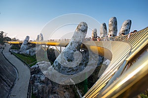 The Golden Bridge is lifted by two giant hands in the tourist resort on Ba Na Hill in Danang, Vietnam.