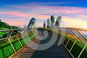 Golden Bridge at sunset in Danang Vietnam photo