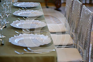 Golden bronze elegant table with four seats and chairs with matching sequins covers