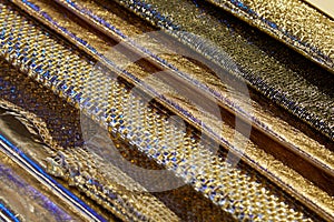 Golden, bronze and metallic tooled leather samples texture background