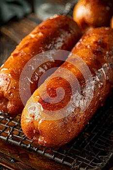 Golden brown corn dogs sizzling in the deep fryer, tempting and cooked to perfection
