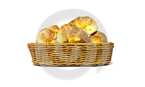 Golden brown croissant in rattan basket