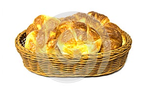 Golden brown croissant in rattan basket