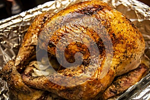 Golden brown roasted turkey with herbs fresh out of the oven