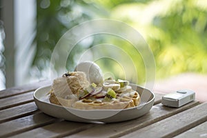 Golden brown waffle topped with ice cream Fruit