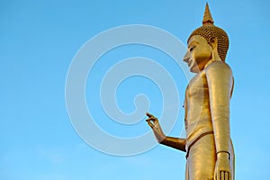 Golden buddha on blue sky backgrond with copy space