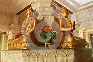 Golden Buddha in the Buddhist temple Brahma Vihara Arama, Bali, Indonesia. Yellow Buddha look beautiful