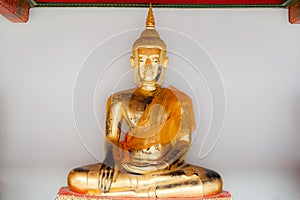 A golden Buddha displayed at Wat Pho, Bangkok, Thailand.