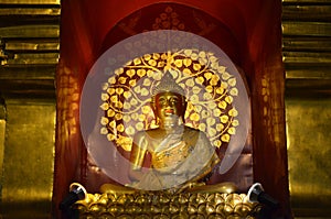Golden Buddha is enshrined in a Samadhi glass wood arch.