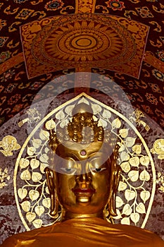 Golden Buddha Face at Wat Chet Yot with buddist ornamentation