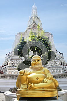 Golden Buddha in front of Wat Arun, the beautiful white Buddhist temple in Bangkok, Thailand