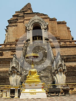 Golden Buddha image at the base of the Wat Chedi Luang stupa in Chiang Mai