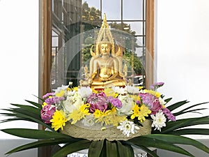 Golden buddha image with beautiful flower