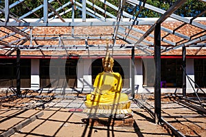 Golden buddha image put on outdoor during temple renovation