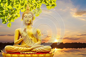 Golden Buddha image under the Bodhi leaf, natural background