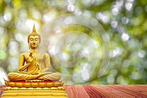 Golden Buddha image under the Bodhi leaf, natural background